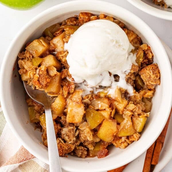 gluten free apple crisp topped with a scoop of vanilla ice cream